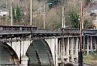 Bridge with broken rails and cracks in pavement from an earthquake